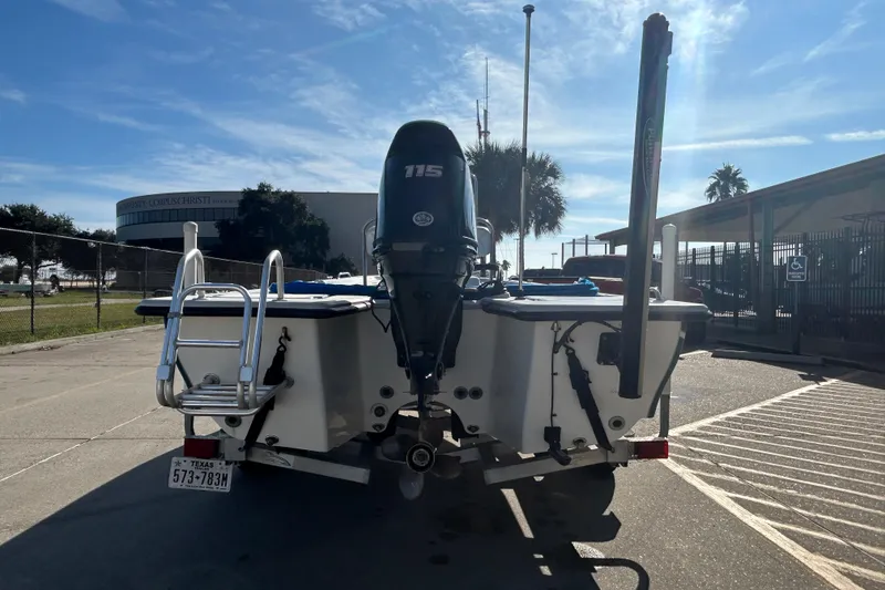 Slide: The Image of 2017 Blue Wave 1900 STL boat with 115 HP motor, parked outdoors. - 6