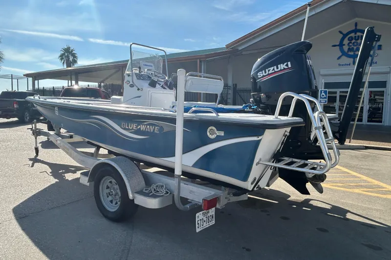 Slide: The Image of 2017 Blue Wave 1900 STL boat with Suzuki motor on trailer, parked outside dealership. - 7