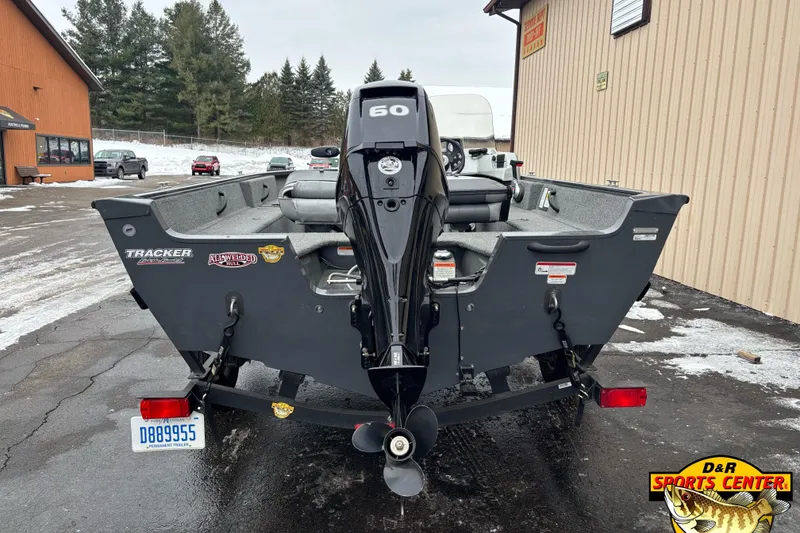 Slide: The Image of 2018 Tracker Pro Guide V-16 SC boat with 60 HP engine, parked outdoors. - 3