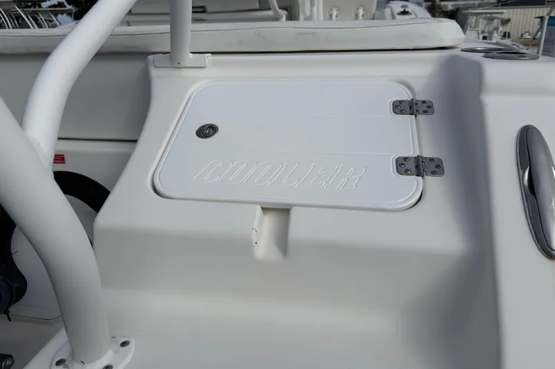 Slide: The Image of 2014 Tidewater 230 LXF boat cooler compartment with secure latch. - 11