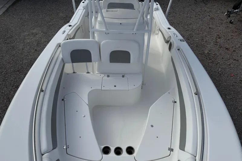 Slide: The Image of 2014 Tidewater 230 LXF boat interior with seating and storage compartments. - 14
