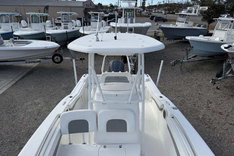 Slide: The Image of 2014 Tidewater 230 LXF boat displayed among other boats in a dealership lot. - 15