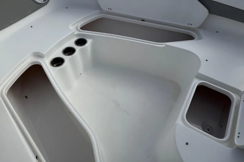 Slide: The Image of 2014 Tidewater 230 LXF boat interior with storage compartments and cup holders. - 17
