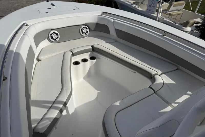Slide: The Image of 2014 Tidewater 230 LXF boat interior with cushioned seating and cup holders. - 24