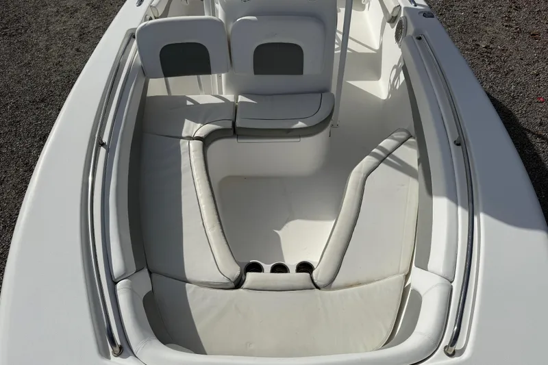 Slide: The Image of 2014 Tidewater 230 LXF boat interior with white cushioned seating and stainless steel rails. - 25