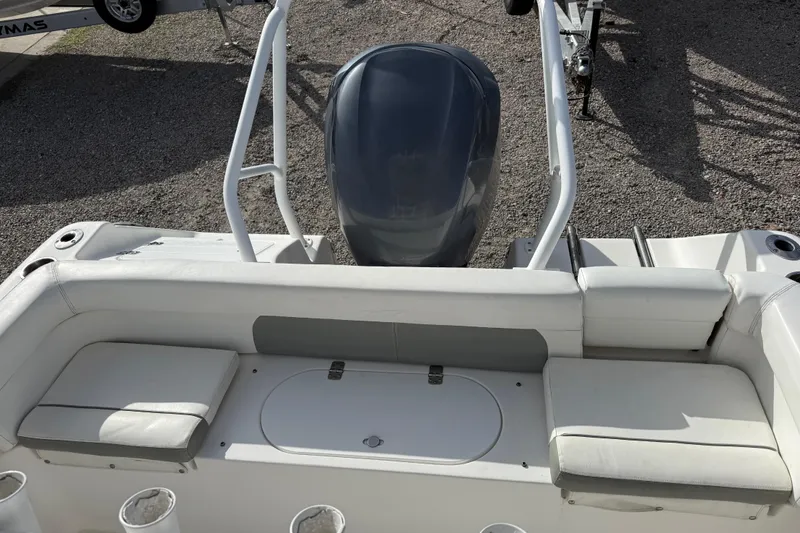Slide: The Image of 2014 Tidewater 230 LXF boat interior with seating and engine view. - 26