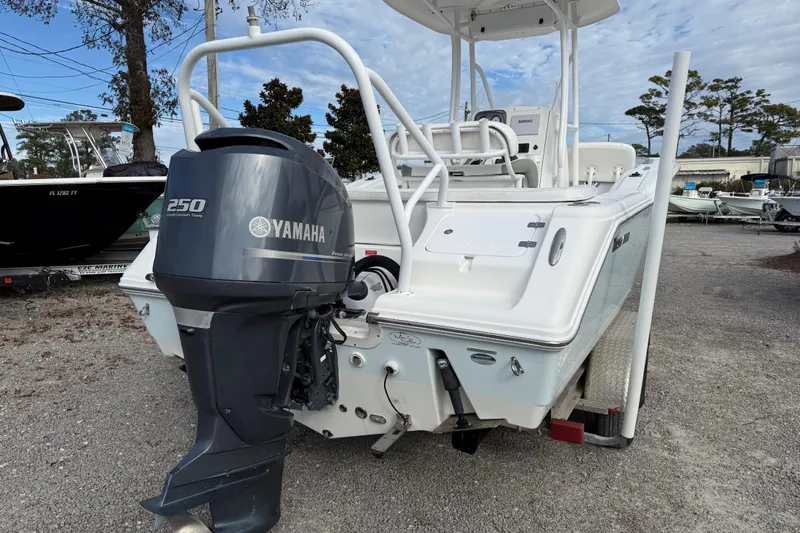 Slide: The Image of 2014 Tidewater 230 LXF boat with Yamaha 250 outboard motor, parked on gravel. - 4
