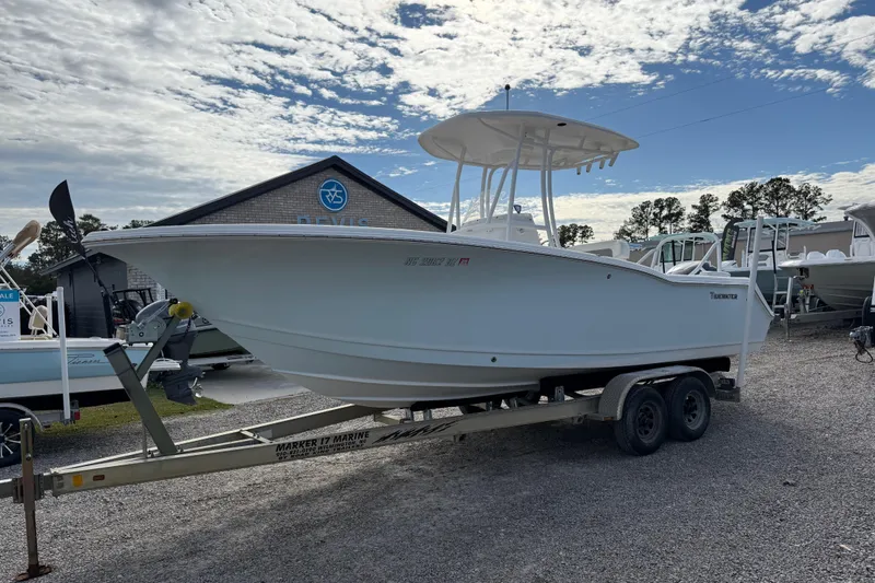 Slide: The Image of 2014 Tidewater 230 LXF boat on trailer under cloudy sky at dealership. - 9