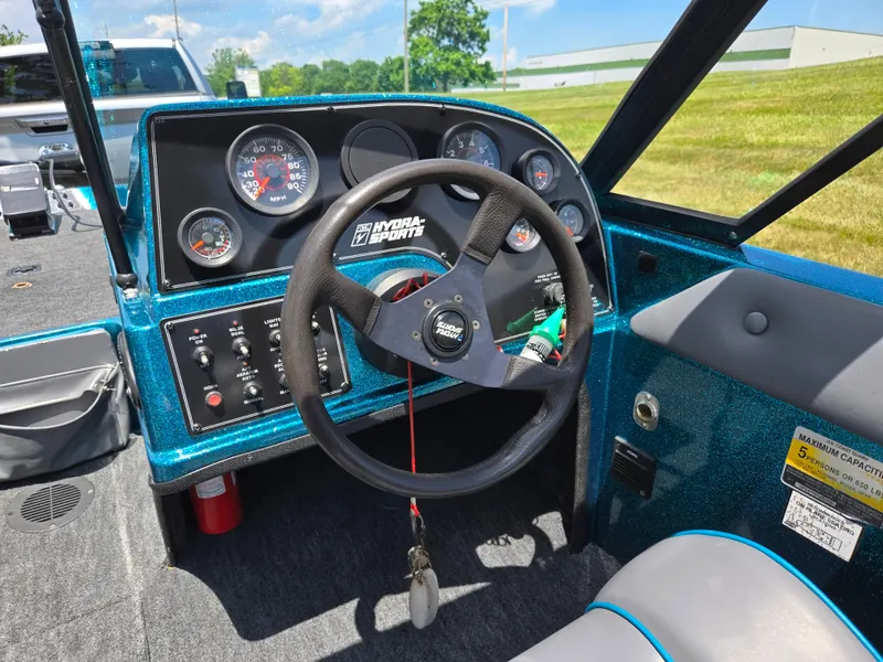 Slide: The Image of 1994 Hydra-Sports 175 FS boat dashboard with steering wheel and gauges. - 13