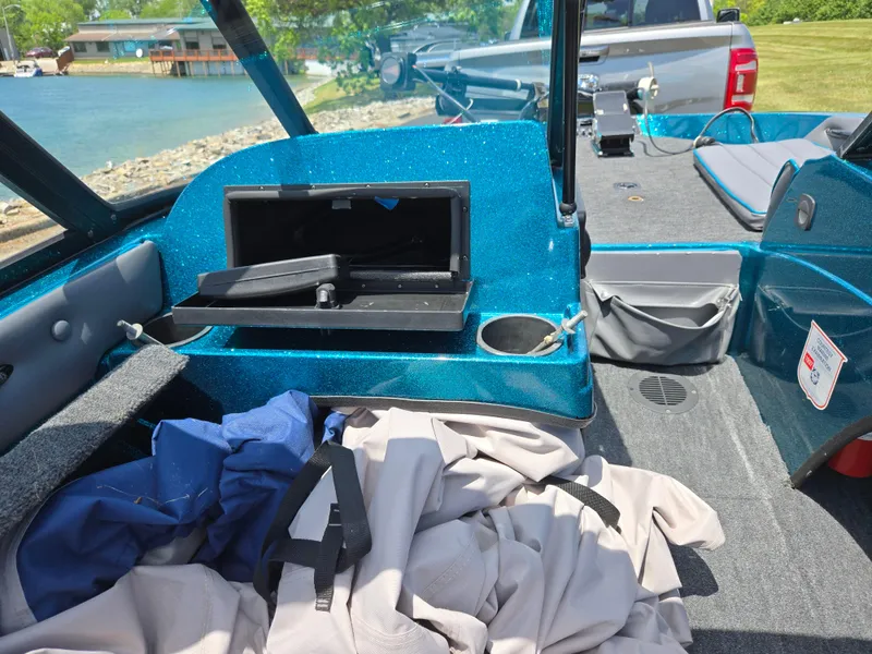 Slide: The Image of 1994 Hydra-Sports 175 FS boat interior with open storage, blue upholstery, and scattered gear. - 15