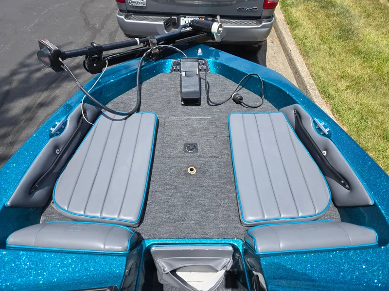 Slide: The Image of 1994 Hydra-Sports 175 FS boat interior with gray seats and blue accents, parked near a vehicle. - 17
