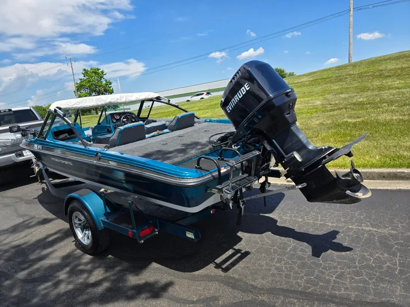 Slide: The Image of 1994 Hydra-Sports 175 FS boat with Evinrude motor on trailer, parked outdoors. - 3