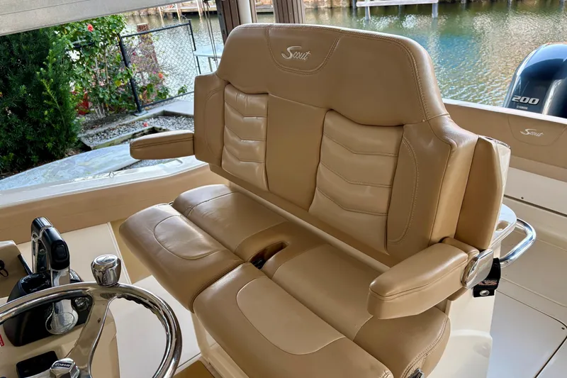 Slide: The Image of 2019 Scout 275 LXF boat interior with tan leather seating and steering wheel. - 10