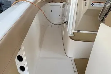 Slide: The Image of 2019 Scout 275 LXF boat interior with beige and white design elements. - 11