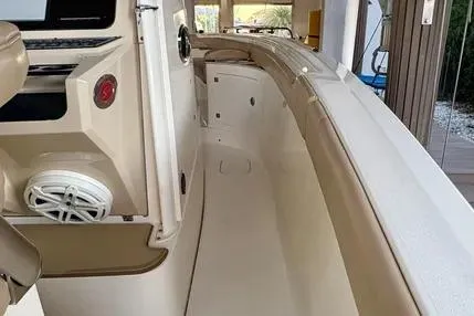 Slide: The Image of 2019 Scout 275 LXF boat interior with beige seating and modern controls. - 9