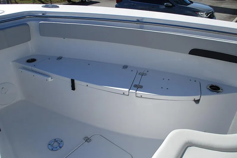 Slide: The Image of 2026 Sea Pro 262 Offshore boat interior with storage compartments and cup holders. - 16