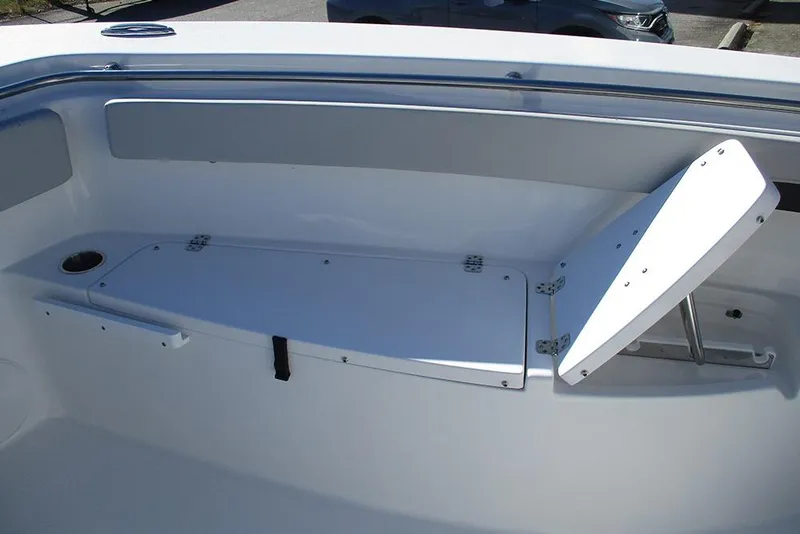 Slide: The Image of 2026 Sea Pro 262 Offshore boat interior with foldable seating and storage compartment. - 17