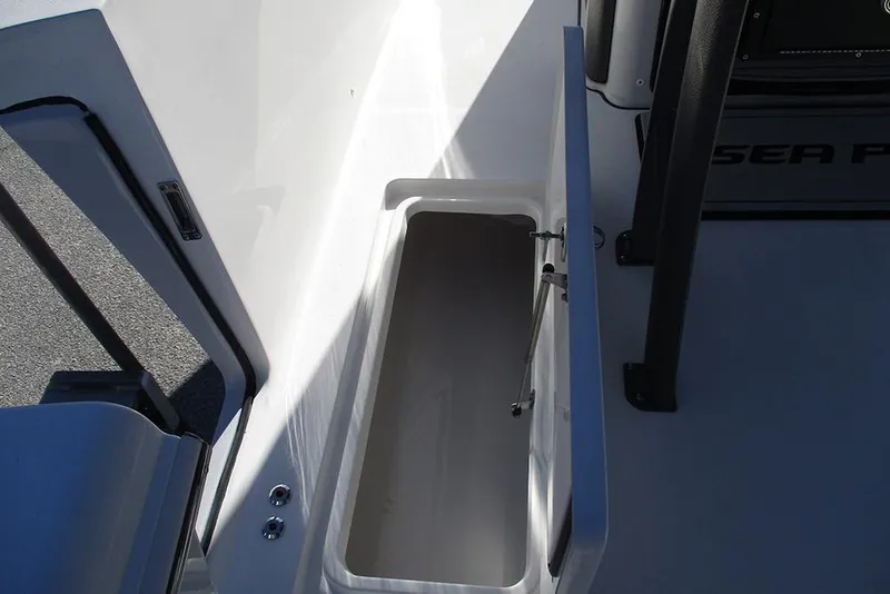 Slide: The Image of 2026 Sea Pro 262 Offshore boat storage compartment with open lid. - 28