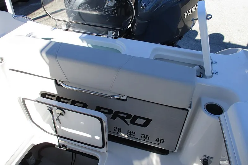 Slide: The Image of 2026 Sea Pro 262 Offshore boat interior with Yamaha engine, featuring seating and storage. - 30