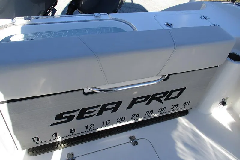 Slide: The Image of 2026 Sea Pro 262 Offshore boat with branded storage compartment and measurement scale. - 34