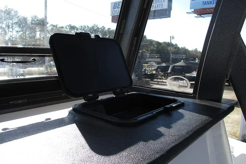 Slide: The Image of Open storage compartment on 2026 Sea Pro 262 Offshore boat dashboard. - 42