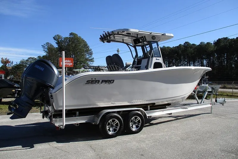 Slide: The Image of 2026 Sea Pro 262 Offshore boat on trailer, featuring Yamaha outboard motor, parked outdoors. - 7