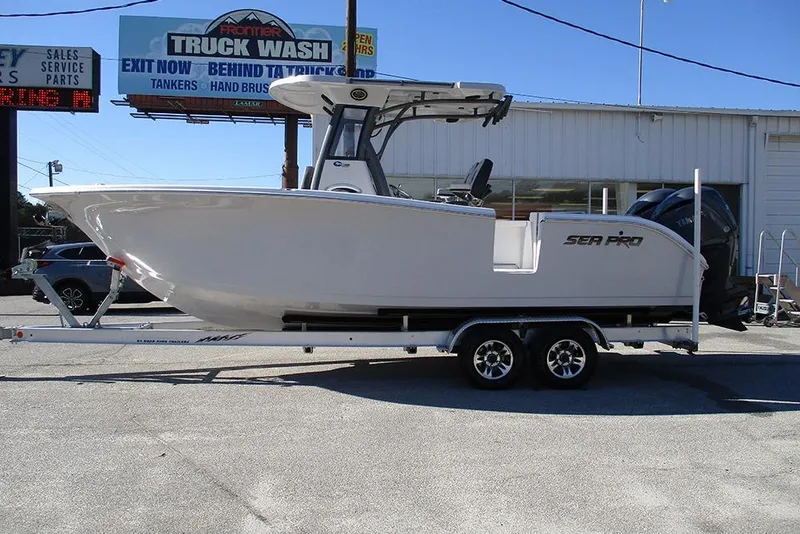 The Image of 2026 Sea Pro 262 Offshore boat on trailer, parked outside a truck wash. - 1