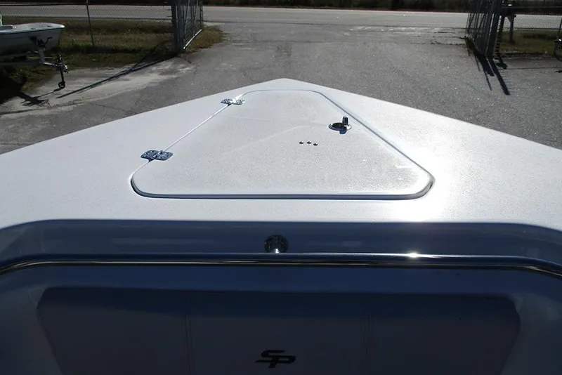 Slide: The Image of 2026 Sea Pro 262 Offshore boat deck with storage hatch, outdoor setting. - 20