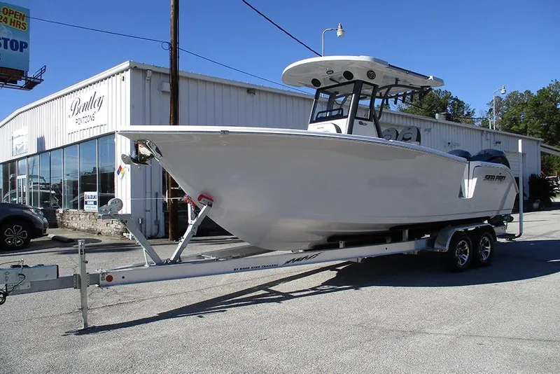 Slide: The Image of 2026 Sea Pro 262 Offshore boat on trailer outside dealership. - 3