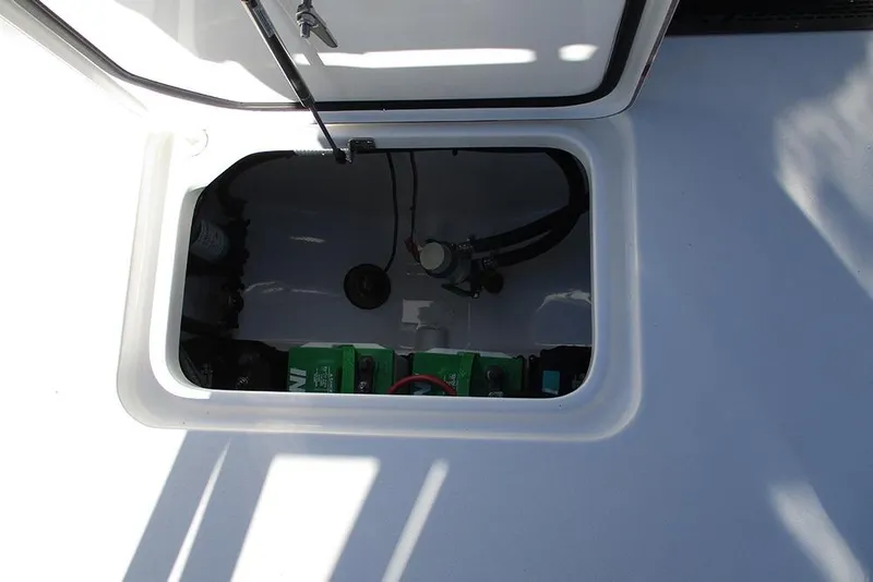 Slide: The Image of 2026 Sea Pro 262 Offshore boat storage compartment with visible battery and wiring. - 31