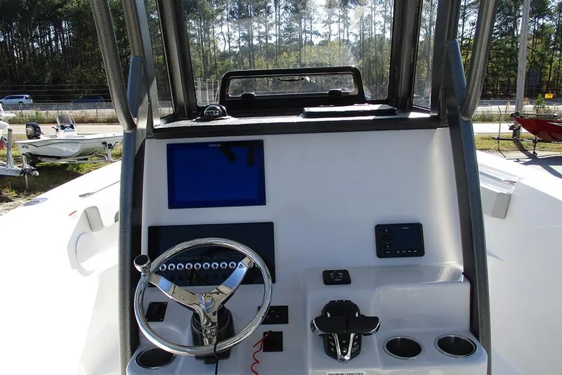 Slide: The Image of 2026 Sea Pro 262 Offshore boat helm with steering wheel and control panel. - 38