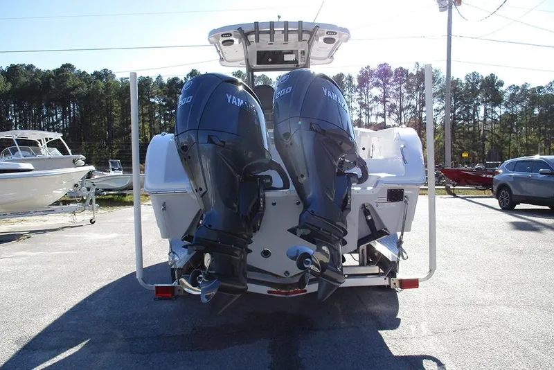 Slide: The Image of 2026 Sea Pro 262 Offshore boat with dual Yamaha outboard engines, parked outdoors. - 8