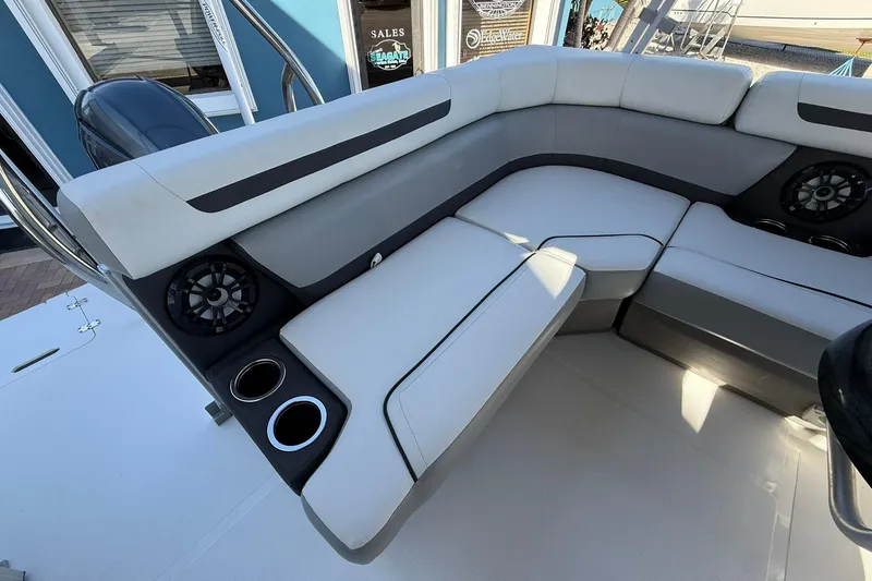 Slide: The Image of 2023 Hurricane FunDeck 2260 RE OB boat interior with cushioned seating and cup holders. - 11