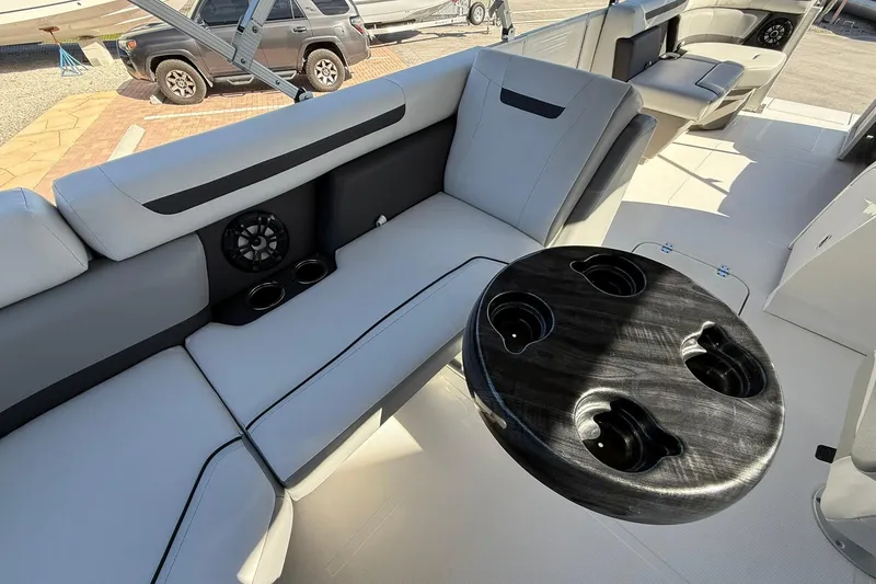 Slide: The Image of 2023 Hurricane FunDeck 2260 RE OB interior with seating and cup holders. - 12