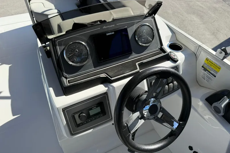 Slide: The Image of 2023 Hurricane FunDeck 2260 RE OB boat dashboard with steering wheel and controls. - 14