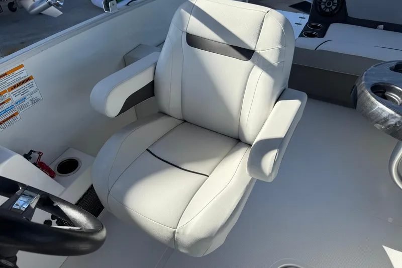 Slide: The Image of Captain's chair on 2023 Hurricane FunDeck 2260 RE OB boat, featuring comfortable design and armrests. - 15