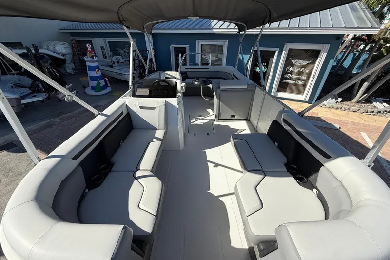Slide: The Image of 2023 Hurricane FunDeck 2260 RE OB boat interior with spacious seating and canopy. - 23