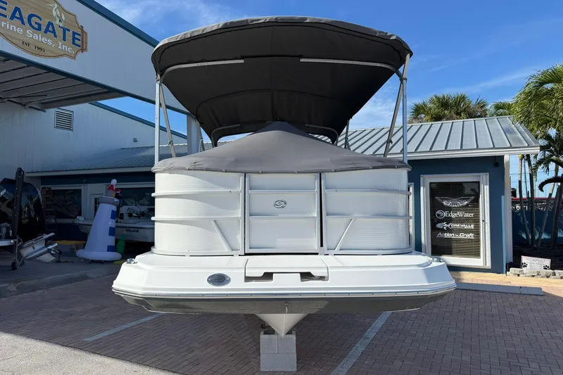 Slide: The Image of 2023 Hurricane FunDeck 2260 RE OB boat displayed at a marine sales dealership. - 3