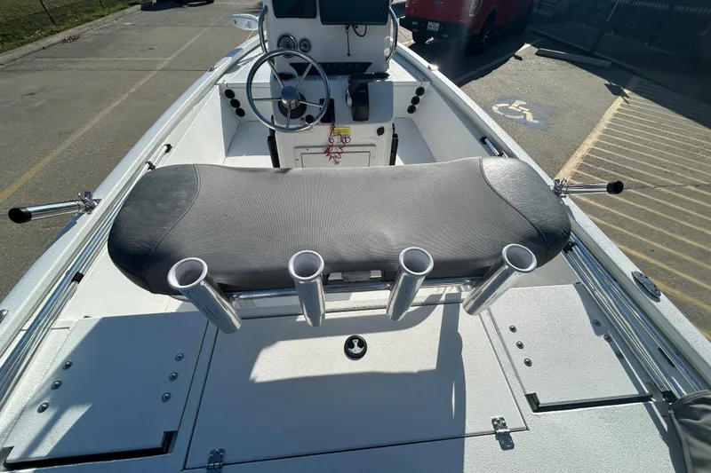 Slide: The Image of 2024 Avid 21 FS boat interior with steering wheel and rod holders. - 11