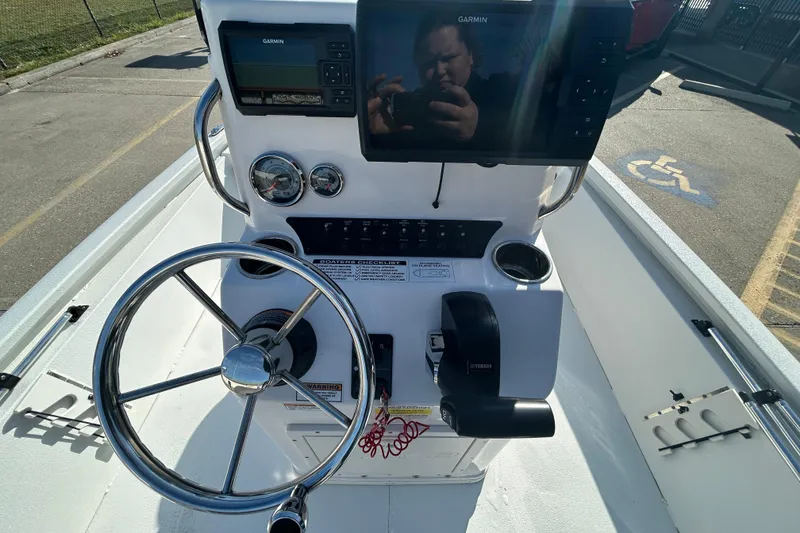 Slide: The Image of 2024 Avid 21 FS boat console with Garmin electronics and steering wheel. - 12