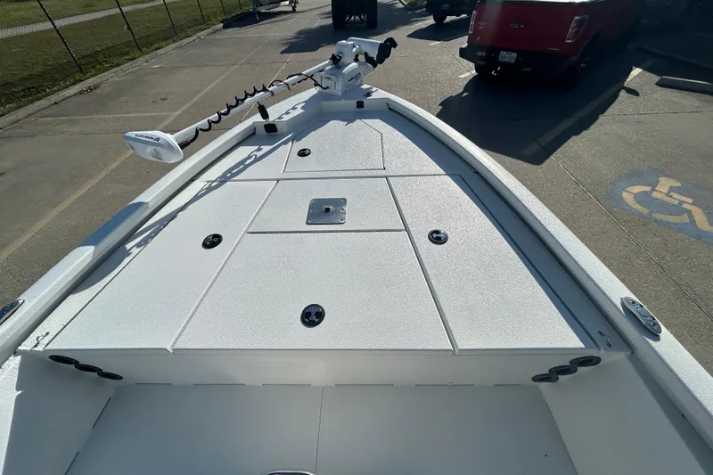 Slide: The Image of 2024 Avid 21 FS boat deck with storage compartments and trolling motor. - 13