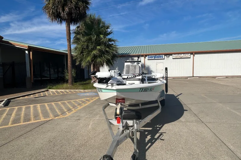 Slide: The Image of 2024 Avid 21 FS boat on trailer in parking lot, sunny day. - 3