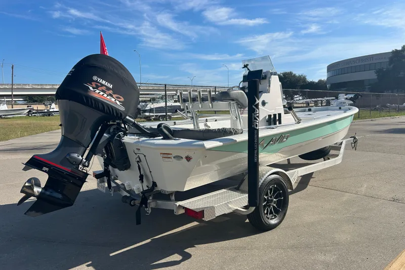 Slide: The Image of 2024 Avid 21 FS boat with Yamaha engine on trailer, parked outdoors. - 5