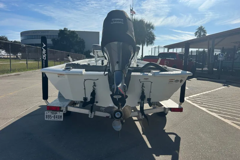 Slide: The Image of 2024 Avid 21 FS boat with Yamaha motor on trailer in parking lot. - 6