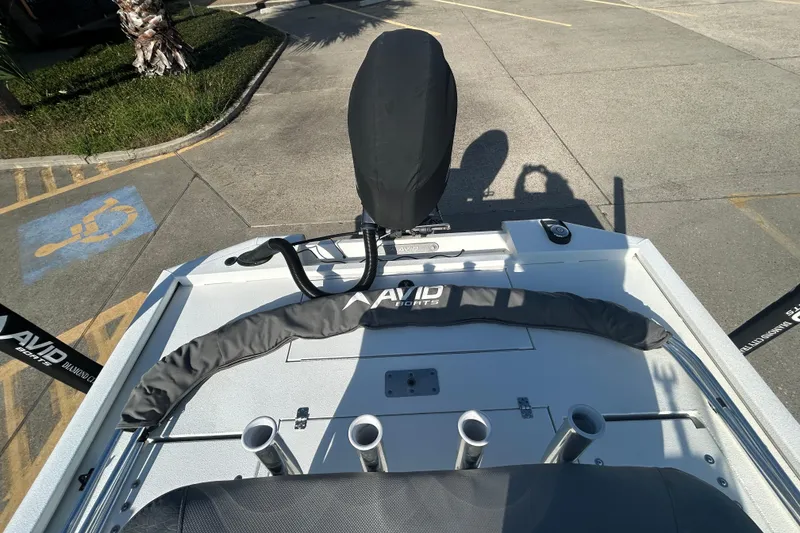 Slide: The Image of 2024 Avid 21 FS boat deck with covered motor and rod holders. - 9