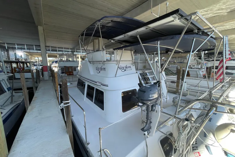 Slide: The Image of 2006 PDQ 34 Power Catamaran docked under a covered marina. - 1