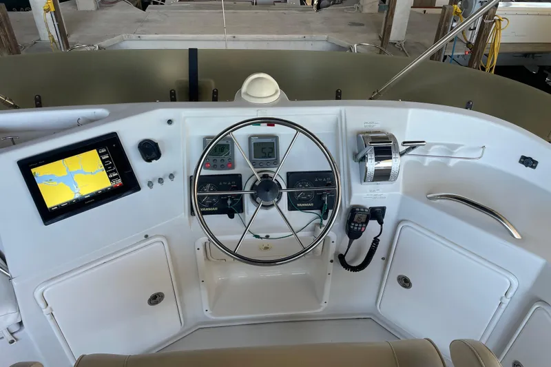 Slide: The Image of Control panel of 2006 PDQ 34 Power Catamaran with navigation screen and steering wheel. - 11