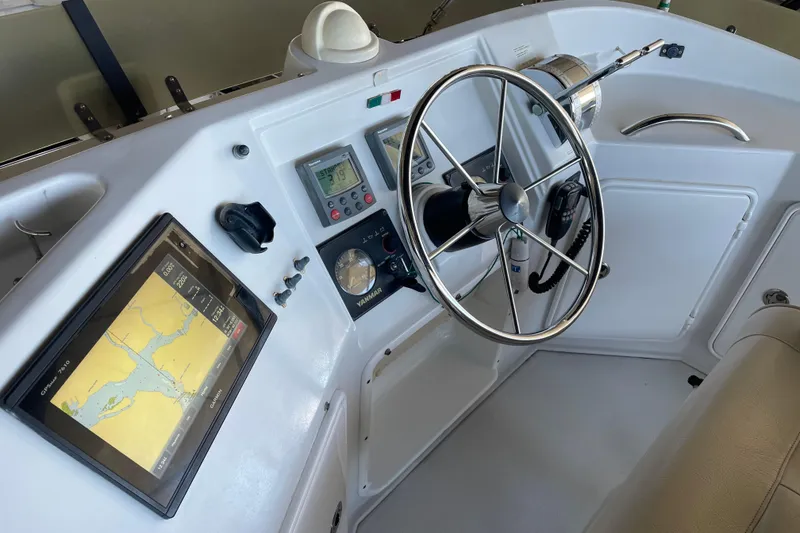 Slide: The Image of 2006 PDQ 34 Power Catamaran helm with navigation display and steering wheel. - 12