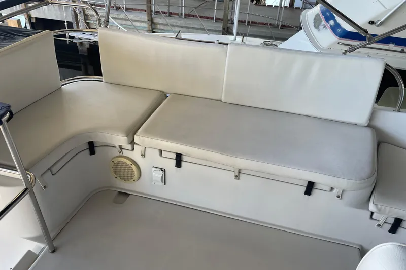 Slide: The Image of 2006 PDQ 34 Power Catamaran seating area with white cushions and speaker. - 13