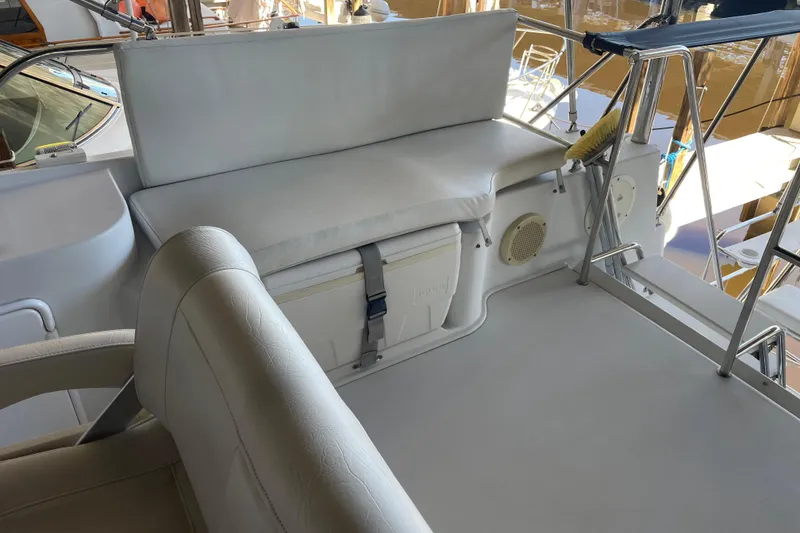 Slide: The Image of 2006 PDQ 34 Power Catamaran interior with cushioned seating and storage. - 14